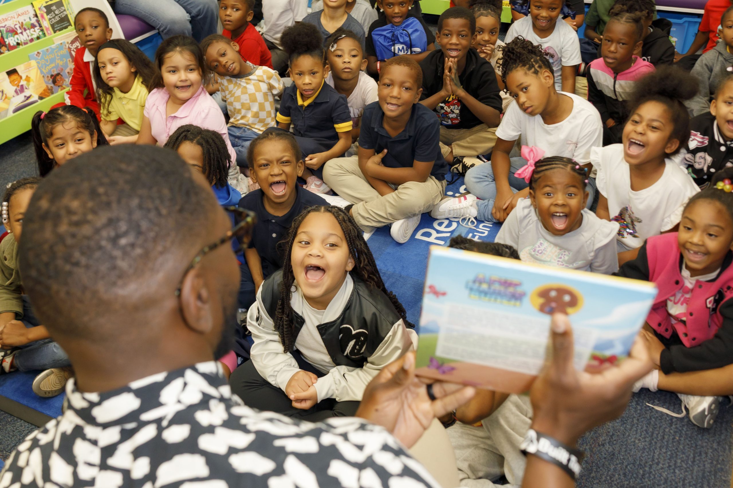 Classroom of kids watching an author read-aloud